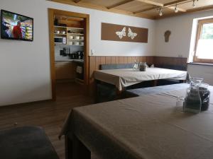 ein Esszimmer mit 2 Tischen und eine Küche in der Unterkunft Appartement Catrin mit Wellnessbereich und Aroma-Anwendungen in Ried im Zillertal