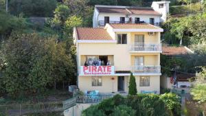 a restaurant with a sign on the side of the building at Hostel Pirate in Ulcinj