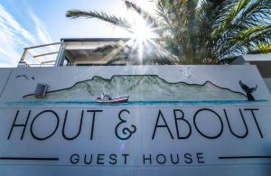 a sign for the front of a guest house at Hout & About Guest House in Hout Bay