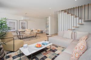a living room with a couch and a table at Liiiving in Porto - Luxury Beachfront Apartments in Porto