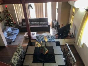 a living room with a christmas tree and a couch at Recanto Do Charão in Gramado