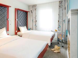 Postel nebo postele na pokoji v ubytování ibis Styles Hotel Berlin Mitte
