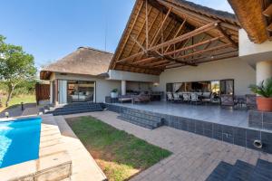 an image of a house with a swimming pool at Zebula - HT1 - 5 Bedroom Holiday Home in Mabula