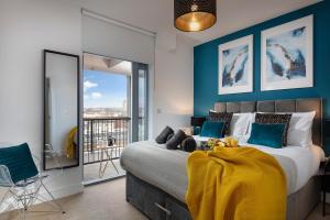 a bedroom with a bed with a yellow blanket on it at PENTHOUSE Plymouth Apartment- Sea View- Sleeps 7 - Private Parking - Habita Property in Plymouth