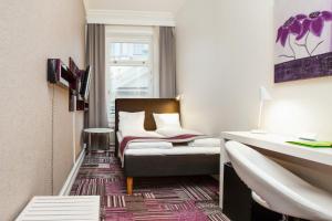 a hotel room with a bed and a window at Ibis Styles Stockholm Odenplan in Stockholm
