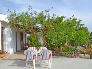 una mesa y sillas en un patio con árboles en Holiday Home Can Niu by Interhome, en Pollensa