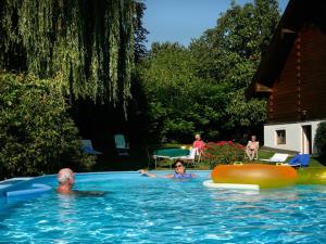 a man and a woman in a swimming pool at Boutique-Hotel Hasenberger in Bad Birnbach