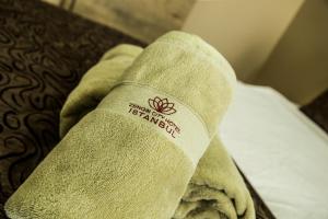 A bed or beds in a room at Zengin City Hotel