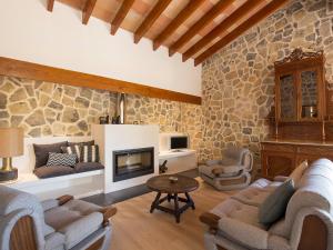 a living room with a stone wall at Holiday Home Can Coll by Interhome in Inca
