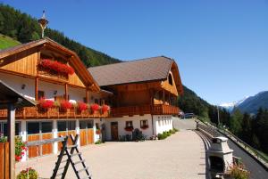 a building with flowers on the balconies of it at Bruneggerhof in Rio Bianco