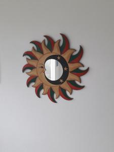 a circular mirror on a white wall at Pousada Beach Eco House Floripa Com Ar Condicionado in Florianópolis +97 photos