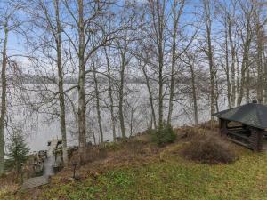 a house sitting on top of a hill next to trees at Holiday Home Oravanpesä by Interhome in Hauho
