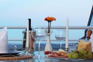 a table with wine glasses and a plate of food at Villa Belohorizonte in Macerata