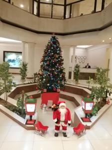 a christmas tree in the middle of a lobby at Andalus Hotel in Baghdād