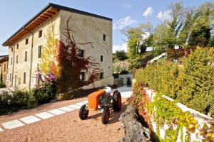 a toy motorcycle parked in front of a building at Agriturismo Corte Patrizia in Caprino Veronese