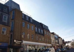a large brick building on a city street at Britannia House 1 bed apartment in Norwich