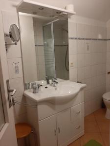ハッセルフェルデにあるFerienzimmer Wenzelのバスルーム(白い洗面台、鏡付)