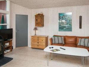 a living room with a couch and a coffee table at 8 person holiday home in Glesborg in Glesborg