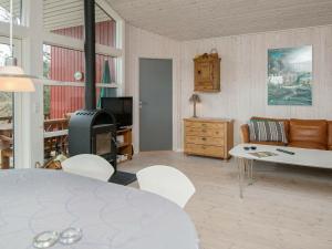 a living room with a table and a couch at 8 person holiday home in Glesborg in Glesborg