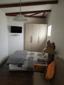 a bedroom with a bed and a couch at Bona Lodge in Cape Town