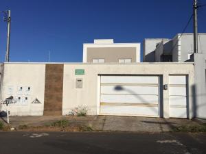 a white building with a large garage door at APARTAMENTO ACONCHEGANTE in Uberlândia