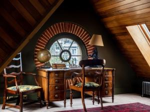 an attic room with a desk and two chairs at The Rookery in London