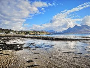 a large body of water with mountains at Raasay House Hotel in Raasay