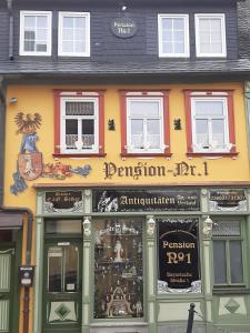 a store front of a building with a sign on it at Pension Antik in Bad Lobenstein