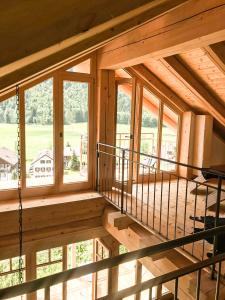 an empty porch of a wooden cabin with windows at Ferienhaus Chalet-Ettal in Ettal