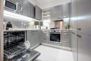 a kitchen with stainless steel cabinets and a dishwasher at Catedral Bas Apartments by Aspasios in Barcelona