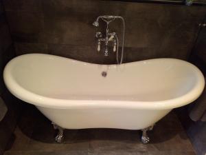a bath tub with a water fountain in a bathroom at Ferienhaus Chalet-Ettal in Ettal