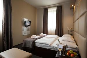 Posteľ alebo postele v izbe v ubytovaní Hotel Villa Völgy Wellness & Konferencia