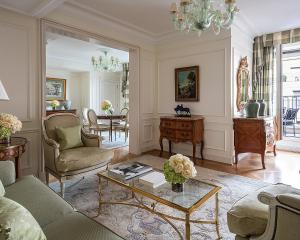 a living room with a couch and a table at Four Seasons Hotel George V Paris in Paris