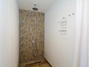łazienka z prysznicem i ścianą wyłożoną kafelkami w obiekcie Luxe Penthouse Casa Atlantica Morro Jable Sea Views By PVL w mieście Morro del Jable +16 zdjęć