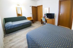 Postel nebo postele na pokoji v ubytování Hotel Italia