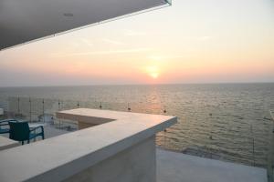 a view of the ocean at sunset from a building at Torre Aguamarina in Campeche
