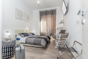 Postel nebo postele na pokoji v ubytování Scirocco Rooms