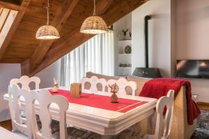 a dining room with a table and chairs and a television at Montcorbison by Totiaran in Vielha