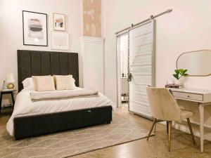 a bedroom with a bed and a desk and a chair at Cozy Downtown Loft in Knoxville