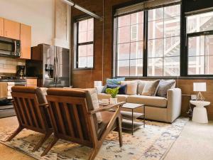 a living room with a couch and a table at Cozy Downtown Loft in Knoxville