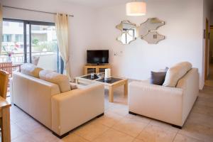 a living room with two couches and a table at Lagos Central Wellness in Lagos