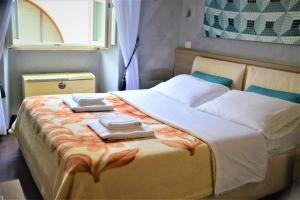 a bedroom with a large bed with two towels on it at Art And Relax Suites in Rome