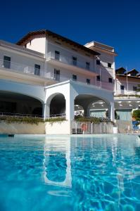 a hotel with a swimming pool in front of a building at Grand Hotel Aminta in Sorrento