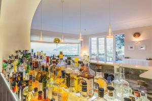 a bar filled with lots of bottles of alcohol at Grand Hotel Aminta in Sorrento