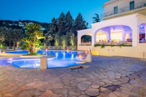 a house with a swimming pool at night at Grand Hotel Aminta in Sorrento