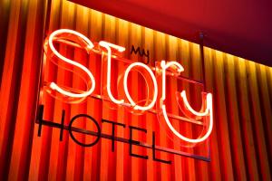 a neon sign hanging from the side of a building at My Story Hotel Rossio in Lisbon