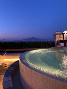 a large swimming pool at a resort at night at Grand Hotel Aminta in Sorrento