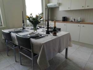 a dining room table with a bottle of wine and glasses at The Mill 2380 in Ravels