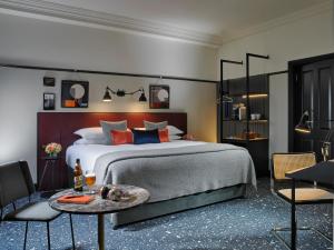 a bedroom with a large bed and a table at The Mont in Dublin
