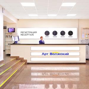 a man standing behind a counter in an airport lobby at Аrt-Volzhskiy in Volzhskiy